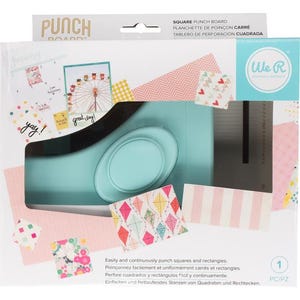 May include: A square punch board in a package with the text "PUNCH BOARD" at the top. The board is teal with a black handle and an oval-shaped punch. The package includes patterned paper samples and the text "We R Memory Keepers".