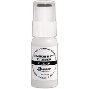 May include: A clear embossing dabber bottle with a white pump top. The label reads "EMBOSS IT DABBER CLEAR" with the Ranger logo and "1 fl oz (34 ml)". The bottle is designed for large stamping surfaces.