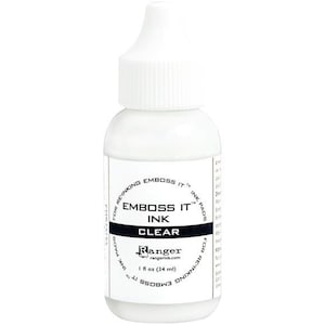May include: A white bottle of "EMBOSS IT" clear ink for re-inking embossing ink pads. The bottle has a white cap and a label with the brand name "Ranger" and the volume of 1 fl oz (34 ml).