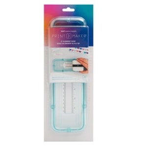 May include: A clear plastic Print Maker kit with a blue and white design. The packaging features the text "Print Maker" and a demonstration of its use. The kit includes a ruler and other tools for crafting and design.