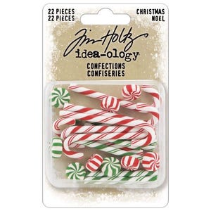 May include: A package of 22 Christmas-themed confections, including red and white striped candy canes and green and white peppermint candies. The package has the text "Jim Holtz Idea-ology" and "Christmas Noel".