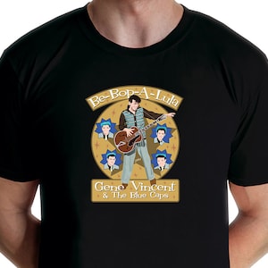 May include: Black t-shirt with a graphic of Gene Vincent and the Blue Caps. The graphic features a cartoon image of Gene Vincent playing a guitar with the words "Be-Bop-A-Lula" above him.