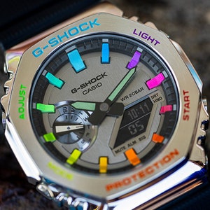 Casio Casioak G shock with stainless steel bezel and black rubber straps. Bezel text and hour markers are painted in a beautiful rainbow gradient