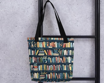 May include: A tote bag with black handles and a dark blue background. The bag is covered in a colorful illustration of bookshelves filled with books and potted plants. The books are in various colors, including red, yellow, and blue.