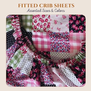 May include: Fitted crib sheets with the text FITTED CRIB SHEETS Assorted Sizes & Colors. The fabric features a patchwork design with various patterns including pink roses on black and white backgrounds, pink and white gingham, and green gingham.