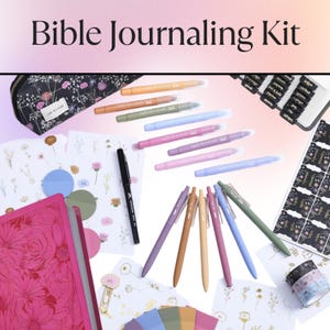 May include: A Bible Journaling Kit with a pink floral journal, pens, markers, stickers, and washi tape. The kit includes a black pencil case with a floral pattern, and the text "Bible Journaling Kit" is at the top.