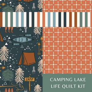 May include: A quilt kit featuring fabric patterns with a dark blue background displaying camping motifs like tents, canoes, and trees, alongside an orange grid pattern with white dots and a striped border. Text reads: CAMPING LAKE LIFE QUILT KIT.