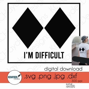 May include: A digital download graphic with two black diamond shapes within a black rectangle, and the text "I'M DIFFICULT" underneath. The design is set against a white backdrop. The image also shows a person wearing a t-shirt with the same design.