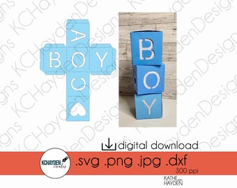 May include: A blue and white paper craft of a box with the letters "BOY" cut out. The box is folded into a cube shape. The image also shows a stack of three blue boxes with the letters "BOY" cut out.