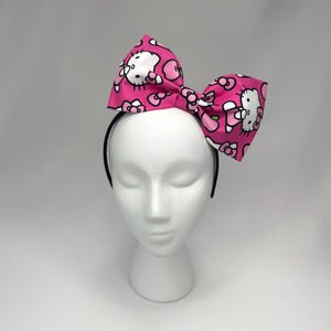 Pink Cartoon Kitty Bow Headband Pink Black White Hair Bow Kitty Lover Fascinator Pink Kitty with Bow Hair Accessory Pink Bow Girls Cheer.