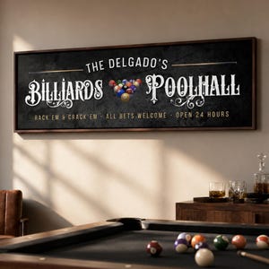 May include: A rectangular wall sign with a dark, textured background featuring the white text THE DELGADO'S BILLIARDS POOLHALL, a graphic of a triangle of billiard balls, and the text RACK'EM & CRACK'EM - ALL BETS WELCOME - OPEN 24 HOURS.