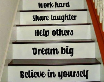 May include: A set of motivational quotes printed on a set of stairs. The quotes are: Be grateful, Stay positive, Love eachother, Exercise daily, Eat healthy, Work hard, Share laughter, Help others, Dream big, Believe in yourself.