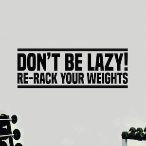 May include: Black and white motivational quote on a gray wall that reads "Don't be lazy! Re-rack your weights".