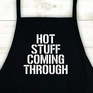 May include: Black apron with white text that reads "HOT STUFF COMING THROUGH".