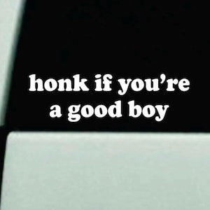 May include: White vinyl car decal with the text "honk if you're a good boy" in a bold, sans-serif font. The decal is displayed on a car window, with a black background.