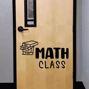 May include: A brown door with a black door handle and a black and white sticker that says "MATH CLASS" with a stack of books next to the word "MATH".
