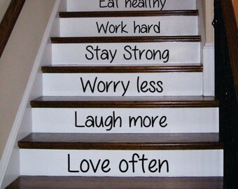 May include: A set of motivational quotes printed on white stair treads. The quotes are: Think positively, Exercise daily, Eat healthy, Work hard, Stay Strong, Worry less, Laugh more, Love often, Be happy.
