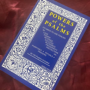 May include: A blue book with a white ornate border and the title "POWERS of the PSALMS" in yellow lettering. The book cover also includes the text "375 WAYS TO USE PSALMS for LOVE POWER REVENGE SUCCESS BLESSINGS PROSPERITY PROTECTION etc. PURPOSES. RITUALS. PRAYERS All 150 Psalms Included ANNA RIVA".
