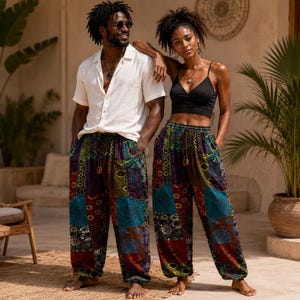 May include: Loose-fitting patchwork trousers featuring a vibrant mix of multicoloured fabric panels with intricate patterns in shades of blue, red, green, and purple, finished with a drawstring waistband and elasticated cuffs at the ankles.
