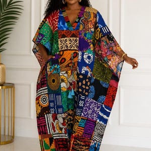 May include: A floor-length kaftan dress featuring a vibrant patchwork design with various geometric, floral, and abstract patterns in shades of red, blue, yellow, green, and black. The garment has a V-neckline, wide sleeves, and a drawstring waist.