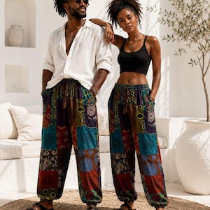 May include: Loose-fitting trousers featuring a patchwork design with various colorful patterns in shades of blue, red, green, and brown. The pants have an elastic waistband with a drawstring, side pockets, and gathered elastic cuffs at the ankles.