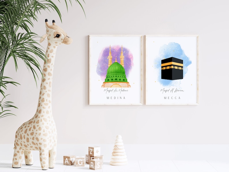 May include: Two watercolor prints of mosques in Medina and Mecca. The print on the left shows the Masjid an Nabawi mosque in Medina with a green dome and two minarets. The print on the right shows the Masjid al-Haram mosque in Mecca with a black cube.