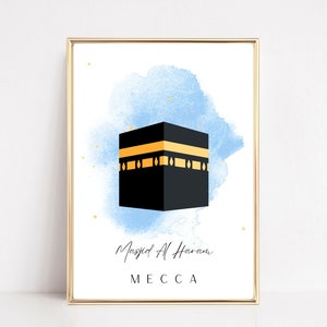 May include: A digital illustration of the Kaaba in Mecca, Saudi Arabia. The Kaaba is a cube-shaped building that is the holiest site in Islam. The illustration is set against a blue watercolor background with gold accents.