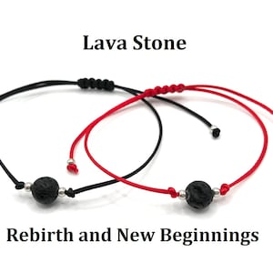 May include: Two lava stone bracelets, one with a black cord and one with a red cord. The bracelets have silver beads and the text "Rebirth and New Beginnings" is written below.