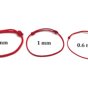May include: Three red cords of different thicknesses, 0.6 mm, 1 mm, and 2 mm, are shown on a white background. The cords are tied in a simple knot at each end.