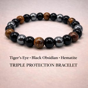 May include: A beaded bracelet featuring Tiger's Eye, Black Obsidian, and Hematite stones. The bracelet has a mix of brown, black, and silver-gray beads. The text "TRIPLE PROTECTION BRACELET" is displayed below the bracelet.