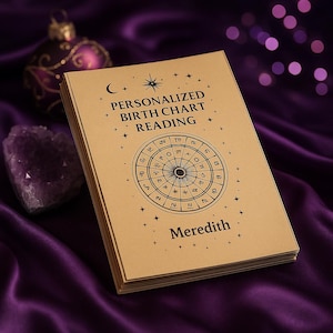 May include: A stack of personalized birth chart readings with the name "Meredith" printed on the cover. The cover is tan with black text and a circular astrological chart design. The background is a deep purple satin fabric.