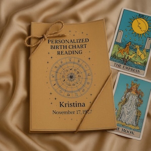 May include: A personalized birth chart reading bound with twine, featuring a zodiac wheel design and the name "Kristina" with a birthdate. Two tarot cards, "The Empress" and "The Moon," are visible. The items are on a beige satin surface.