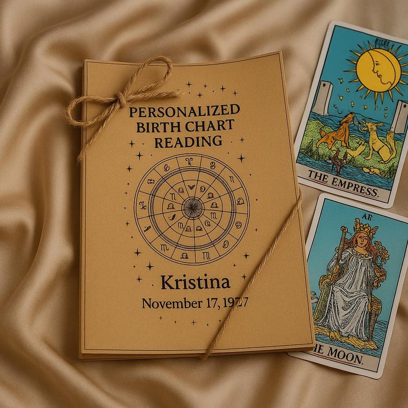 May include: A personalized birth chart reading bound with twine, featuring a zodiac wheel design and the name "Kristina" with a birthdate. Two tarot cards, "The Empress" and "The Moon," are visible. The items are on a beige satin surface.