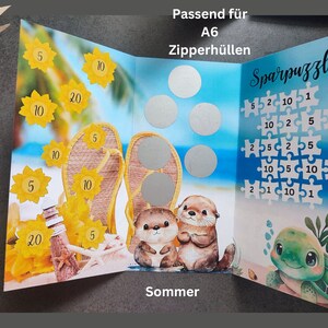 May include: A tri-fold savings tracker card featuring a beach theme with flip-flops, otters, and a turtle. The card includes yellow sunflower icons with numbers, silver scratch-off circles, and a puzzle grid labelled Sparpuzzle.