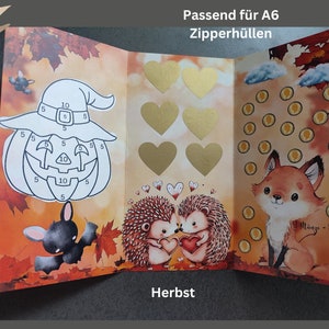 May include: A tri-fold card featuring autumn leaves, a pumpkin with numbers, a bat, six gold hearts, two hedgehogs, and a fox with coin icons. Text reads Passend f&uuml;r A6 Zipperh&uuml;llen and Herbst. The fox graphic includes the text 1 M&uuml;nze - 5 Euro.