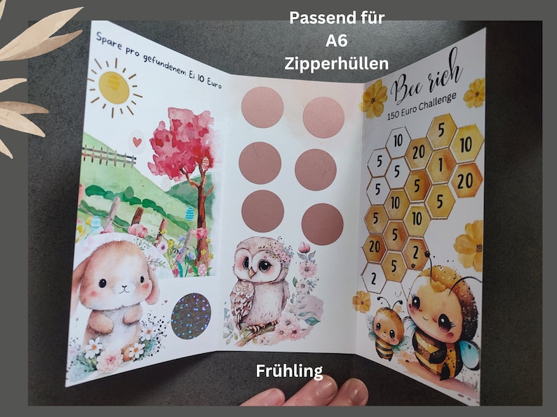 May include: A tri-fold savings challenge card featuring a spring theme with a bunny, owl, and bees. The card includes text: Passend f&uuml;r A6 Zipperh&uuml;llen, Spare pro gefundenem Ei 10 Euro, Bee rich, 150 Euro Challenge, and Fr&uuml;hling. It has six circular scratch-off areas.