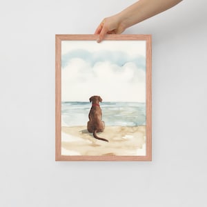 May include: Watercolor painting of a brown dog sitting on a beach, looking out at the ocean. The dog has a red collar and is facing away from the viewer. The sky is blue with white clouds.