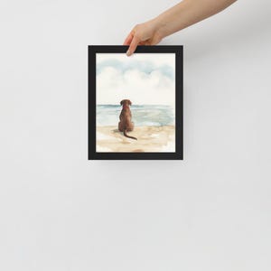 May include: Watercolor painting of a brown dog sitting on a beach looking out at the ocean. The sky is blue with white clouds.
