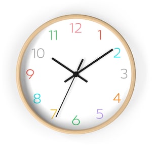 May include: A white clock face with black hands and colorful numbers. The numbers are in a rainbow pattern, with red at the top, orange at the 4, yellow at the 7, green at the 6, blue at the 2, and purple at the 5. The clock has a wooden frame.