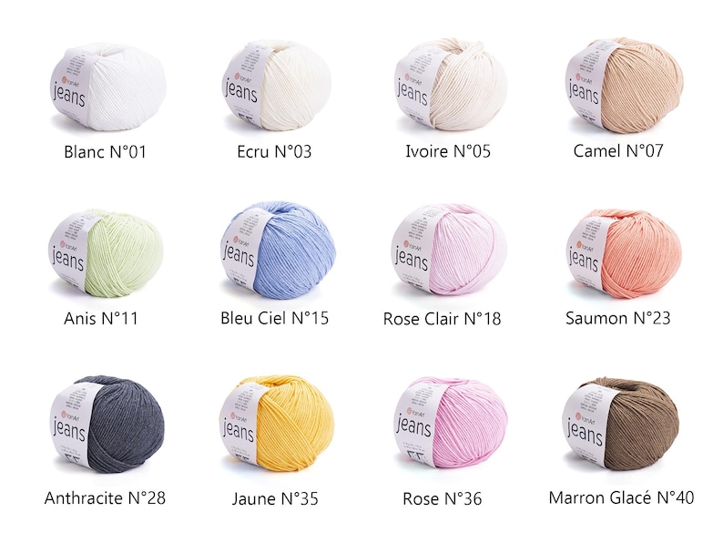 May include: A collection of twelve yarn balls in various colors, including white, beige, light green, blue, pink, and brown. Each ball has a label with the word "jeans" and a color name. The colors are labeled with numbers.