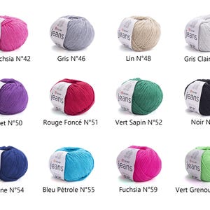 May include: A collection of colorful yarn balls in various shades, including pink, gray, green, and blue. Each ball has a label with the word "jeans" and a color name. Ideal for knitting and crochet projects.