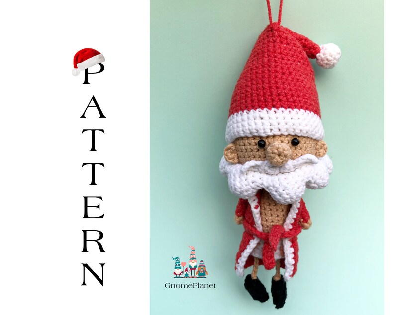 May include: Crocheted Santa Claus ornament with a red hat, white beard, and a red robe. The ornament is hanging from a white string.