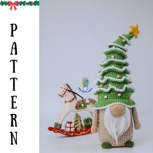 May include: A crocheted Christmas gnome wearing a green Christmas tree hat with white trim and a gold star on top. The gnome is holding a small rocking horse with a red base and a white horse. The gnome has a white beard and a beige body.