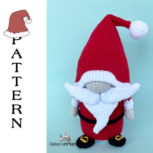 May include: A crocheted Christmas gnome wearing a red Santa hat with a white pom-pom. The gnome has a white beard and a black belt.