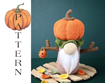 May include: Crocheted pumpkin gnome with a white beard and brown arms. The gnome is wearing a green hat and holding a small orange pumpkin. The gnome is sitting on a wooden platform with fall leaves.