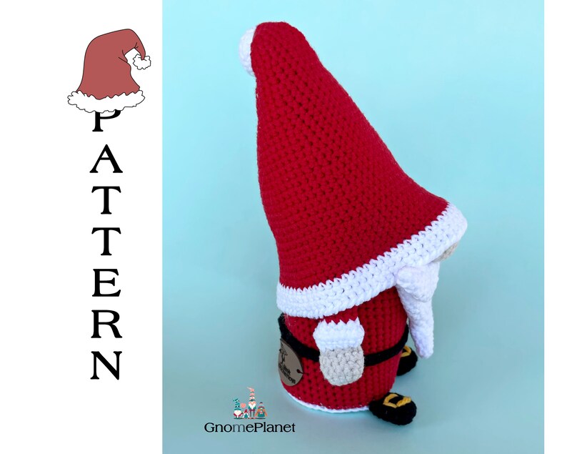 May include: A crocheted Christmas gnome with a red hat, white trim, and a white beard. The gnome is wearing a black belt and has brown shoes.