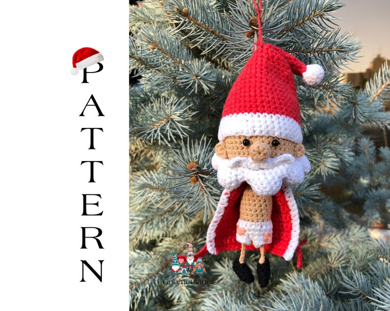 May include: Crocheted Santa Claus ornament with a red hat, white beard, and brown body. He is wearing red and white underwear and a red cape. The ornament is hanging on a green pine tree.