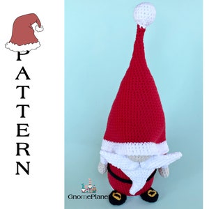 May include: A crocheted Christmas gnome with a red hat, white beard, and black boots. The gnome is standing on a light blue background.