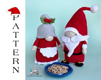 May include: Two crocheted gnomes, one wearing a red hat and the other a gray hat with a holly sprig, stand next to a plate of cookies. The gnomes are dressed in red and white, and the plate is blue.