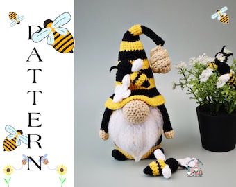 May include: A crocheted bee gnome with a black and yellow striped hat, a white beard, and a beehive on the side. The gnome is holding a small crocheted bee in its hand. The gnome is standing on a light blue surface. The word "PATTERN" is written in black letters on a white background to the left of the gnome.